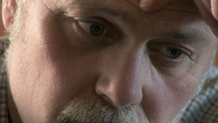 Big close up of man's face, deep in concentration during a chess game.