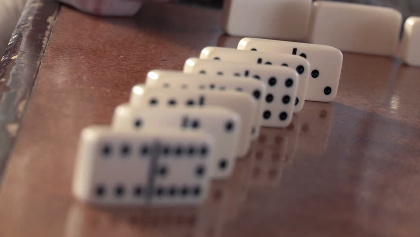 Tilted close up on dominoes being checked, shallow depth of field.