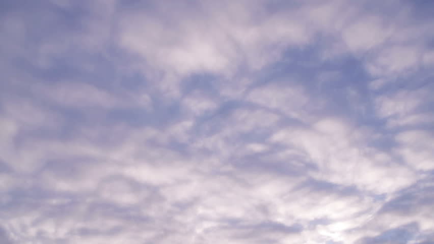 Time lapse of quilted cloud patterns passing from right to left as the sky