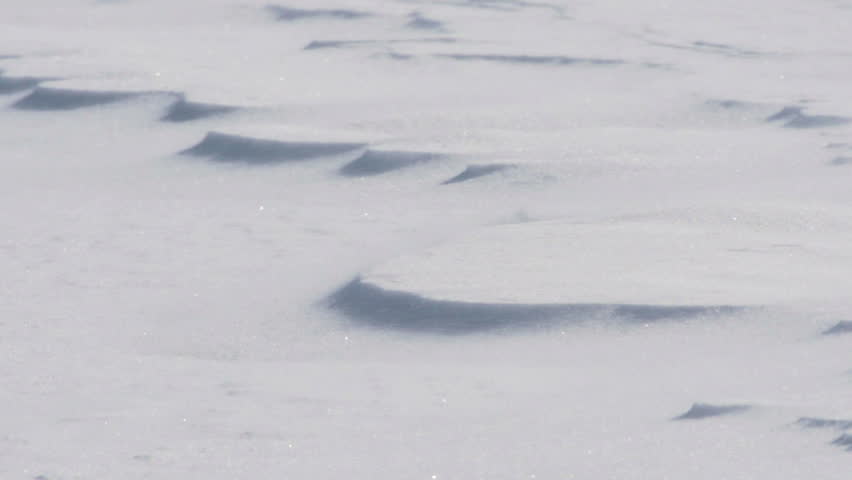 Close-up view of windswept sparkling snowy winter landscape 