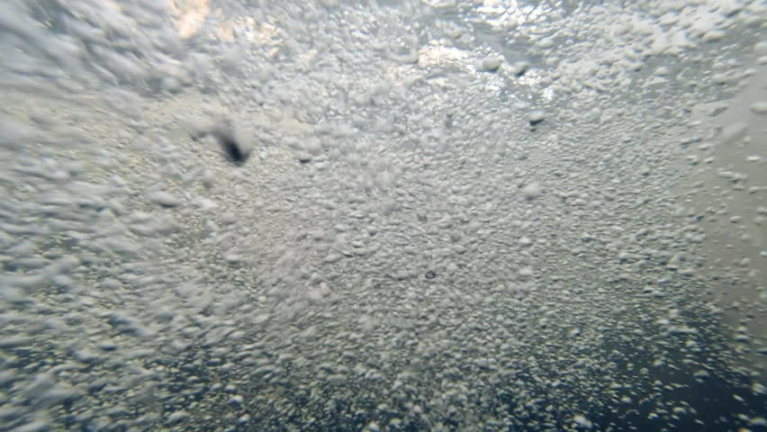Underwater view of bubbling river rapids