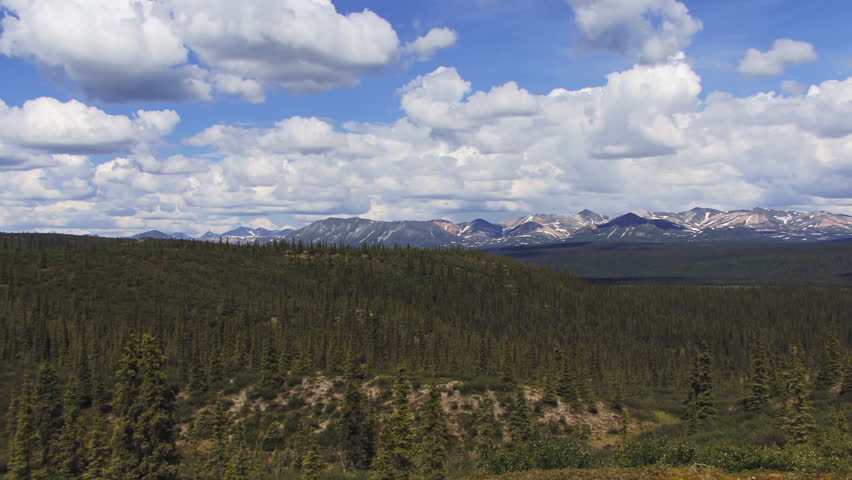 Scenic time lapse shows clouds in motion over beautiful vast open landscape with