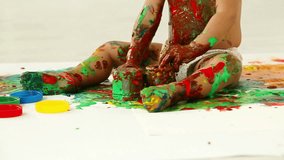 Cute little girl mixing paints so that the color is unidentifiable
