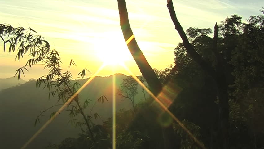 Ray of Sunlight at sunset.Panning shot scene,backside is Mountain and fog on Sky.can change this footage to 16:9