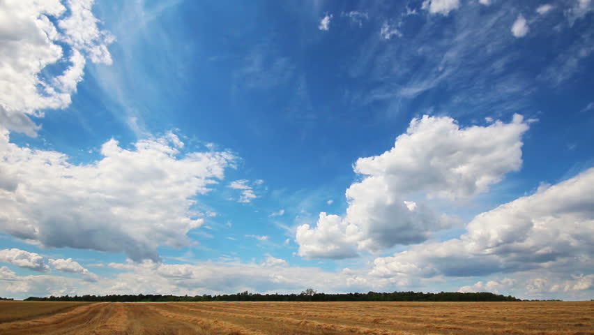 timelapse with clouds moving over yellow field