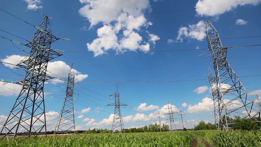tall electric masts against cloudy sky - timelapse