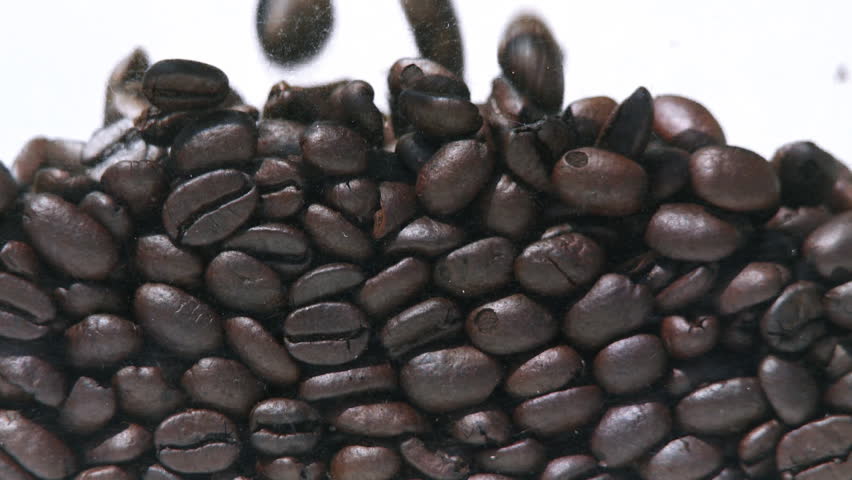 Coffee beans filling up the screen against a white background.  Recorded with