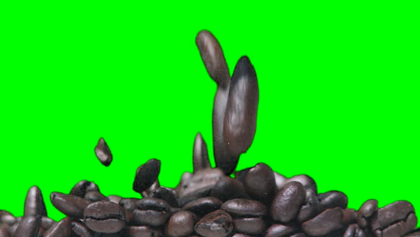 Coffee beans filling up the screen against a green background.  Recorded with