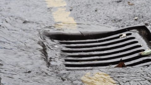 Water pouring into drain during storm