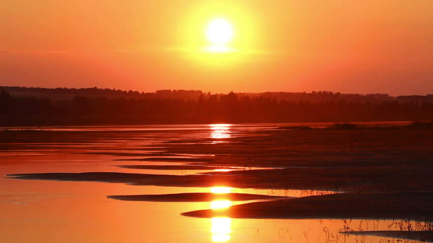 beautiful orange sunset with waved river sand beach - timelapse