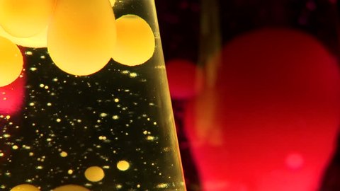 Detail of two lava lamps, useful for abstract backgrounds and patterns.  Focus on foreground, yellow lamp.