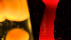 Detail of two lava lamps, useful for abstract backgrounds and patterns.  Colors change while clip plays.