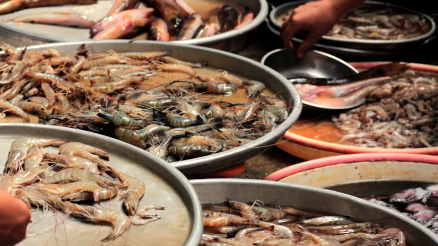 Fresh shrimps, prawns and other seafood at fish market stall, Vietnam, Hochiminh