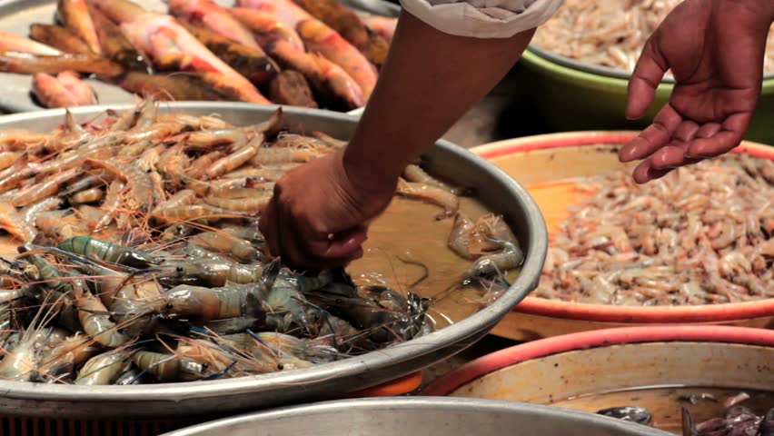 Shrimps being stirred by hand in a open air seafood market, Vietnam, Hochiminh