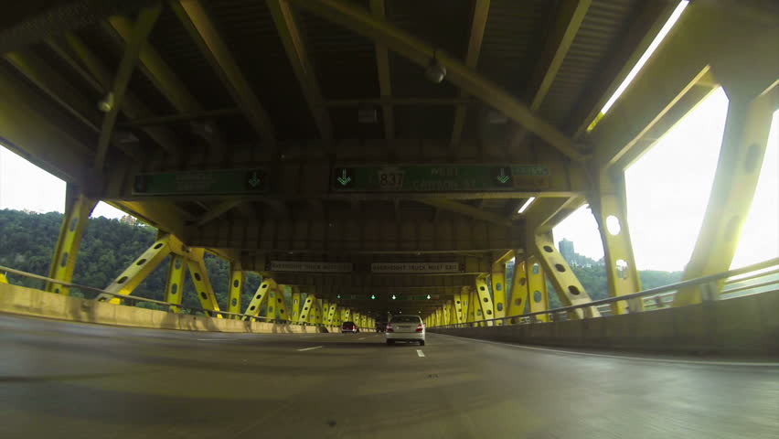 A low-angle perspective of driving into the Fort Pitt Tunnels leaving downtown