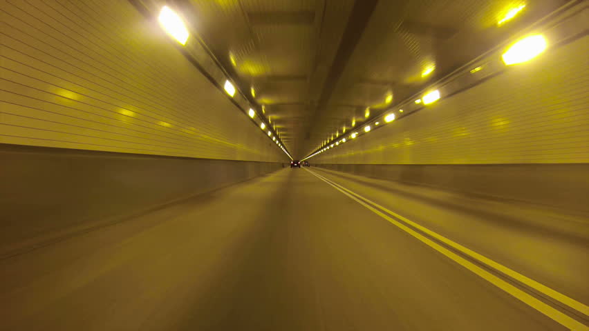 A low-angle perspective of driving into the Fort Pitt Tunnels near downtown