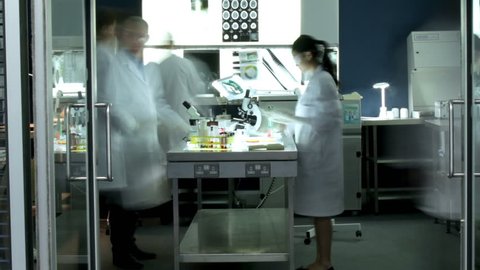 Time lapse of a diverse team of researchers working in a laboratory facility. Could be a forensics science team, medical research or students at a university or college.