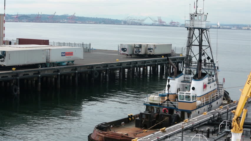 Tug boat oil fuel barge Seattle Washington industrial port. Service large luxury cruise ships as well as big commercial fishing and cargo boat fleet. Pumps into ship and boat while in the marina port.