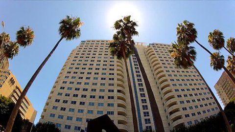 LONG BEACH, CA/USA: July 17, 2013- A low angle shot rolling by high rise condominium buildings in the downtown area circa 2013 in Long Beach. Long Beach is a major tourist and convention destination. 