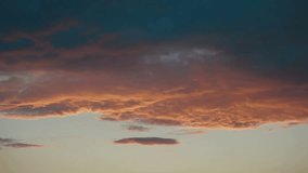 Dramatic Sunset Sky, Timelapse. Clouds lit by the setting sun, and within the film become more dark.