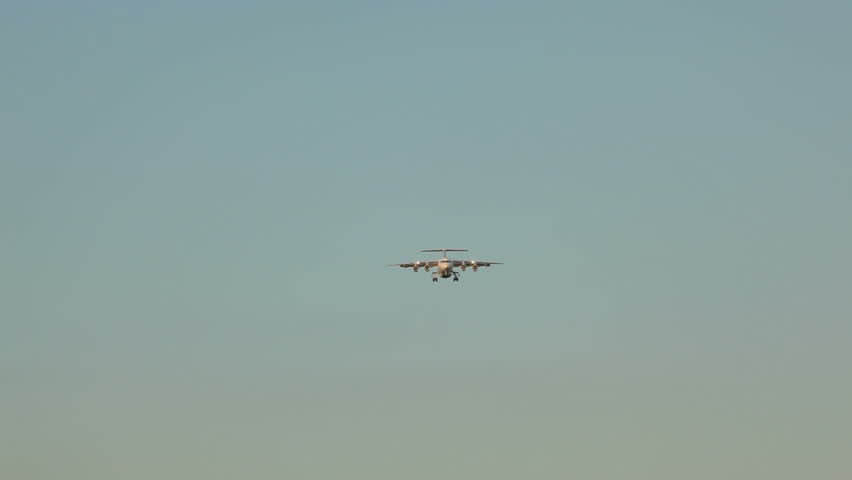 plane approaching for landing at sunset
