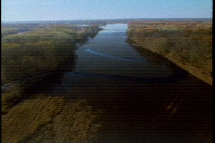 Aerial over calm Penobscot River with lots of trees on riverbanks in Maine.