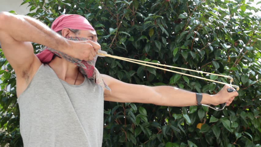 masked man with sling