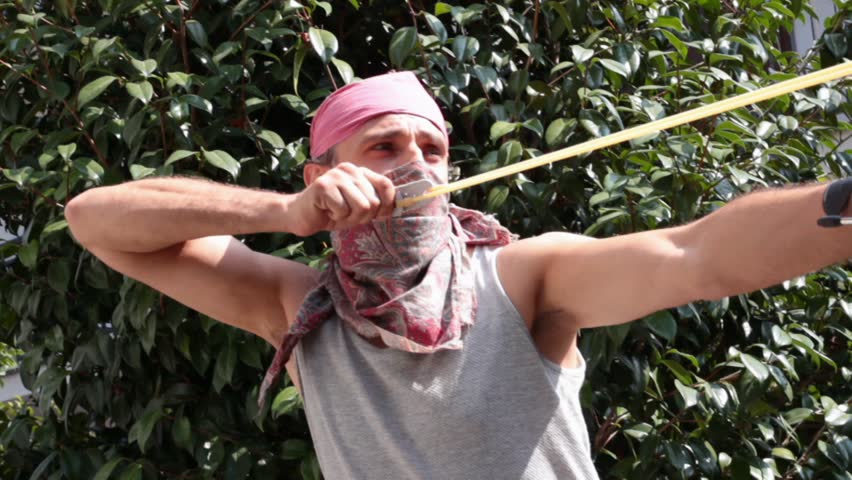 masked man with sling