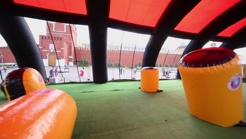People walk near under roof playground for paintball games on red square in Moscow