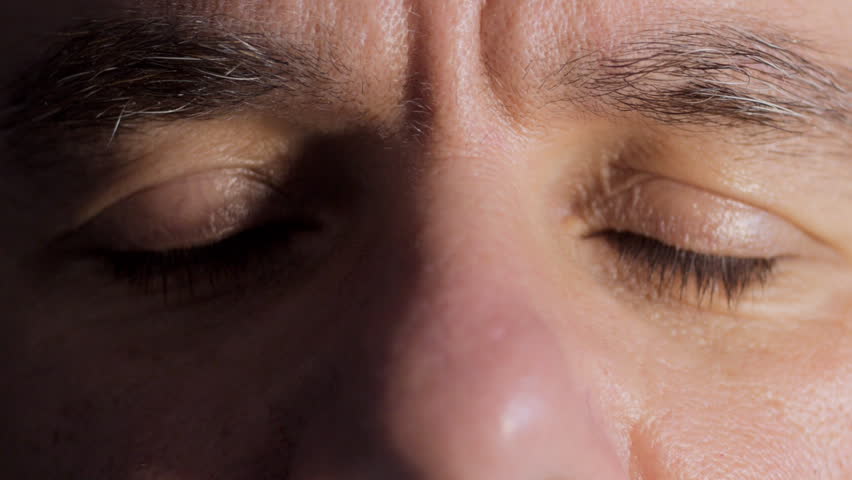 Close up of middle aged man's eyes opening