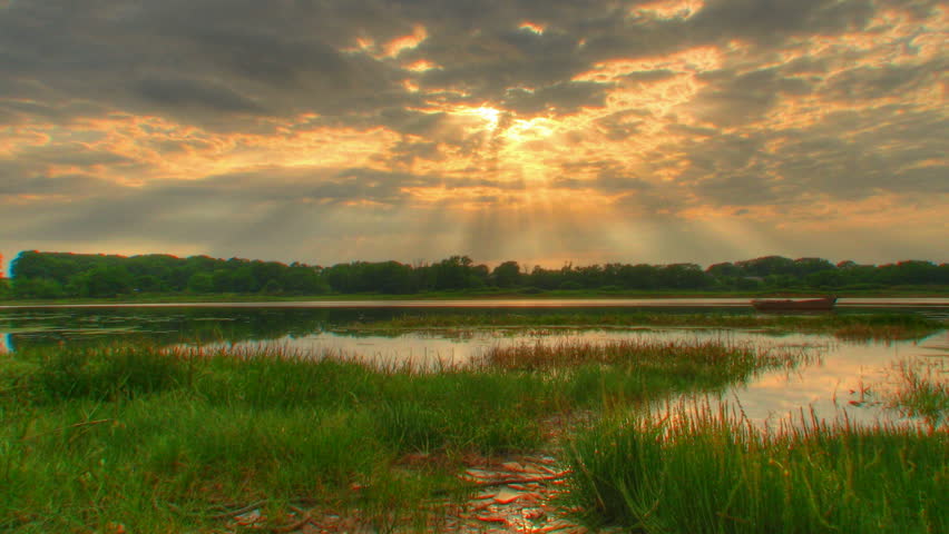 Sunset beams over water, HD time lapse clip, high dynamic range imaging