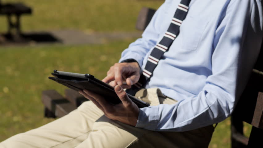 Business man outside with tablet pc
