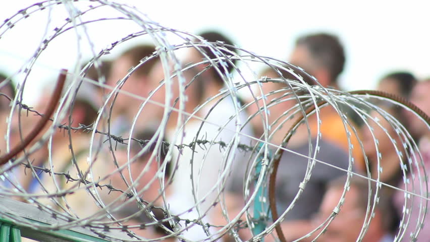Barbed wire with people on background