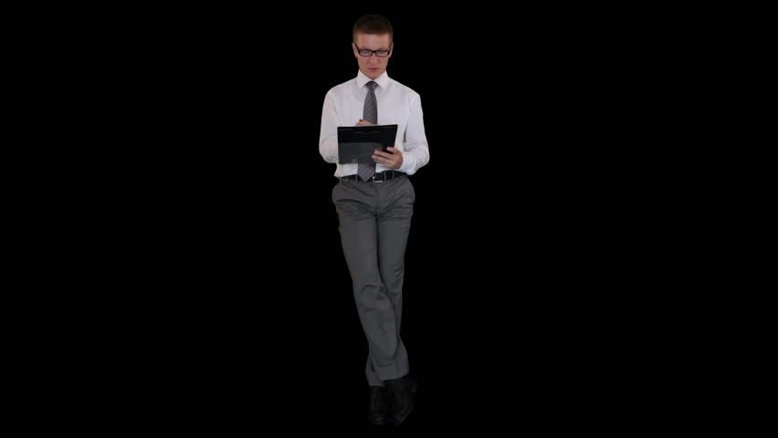 Young businessman with glasses writting on a clipboard and sitting, against