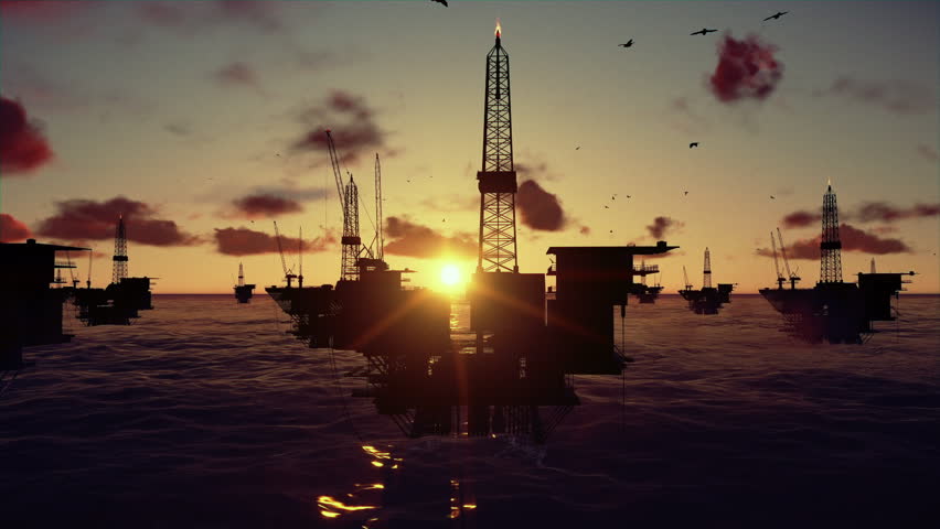 Oil rigs in ocean, time lapse sunset
