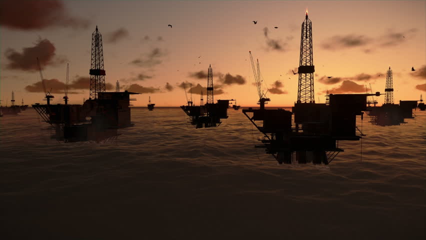 Oil rigs in ocean, timelapse sunrise