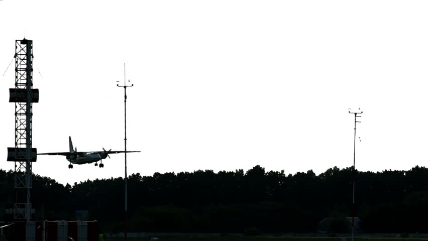 Dusk landing at airport. Aircraft lowers to land wireframe tower