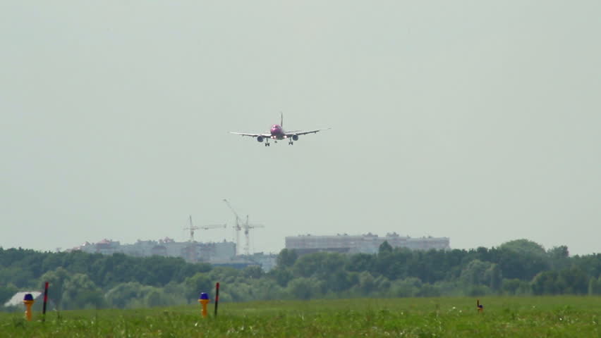 Landing aircraft slowly approaching airport at daytime