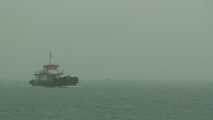 Tug boat sailing in storm