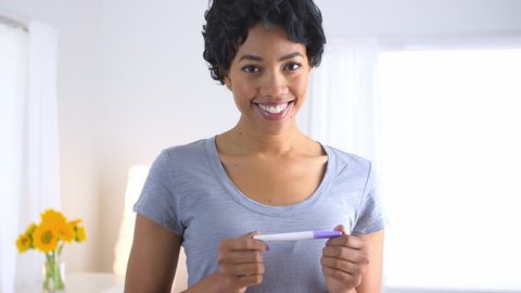 Happy African American woman with pregnancy test Stock Video