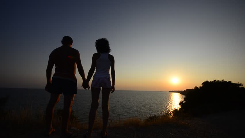 Couple love At Sunset, HD1080: Couple as a silhouette walk in scene hugging on a