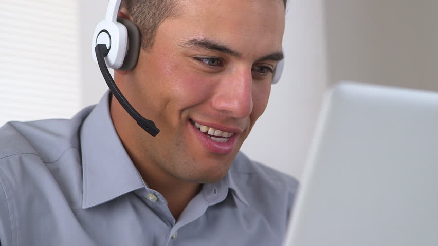 Friendly Hispanic telemarketer working at computer Royalty-Free Stock Footage #4377827
