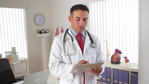 Hispanic doctor using tablet screen to show sonogram