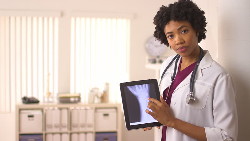 Female African American doctor using tablet pc to display x rays