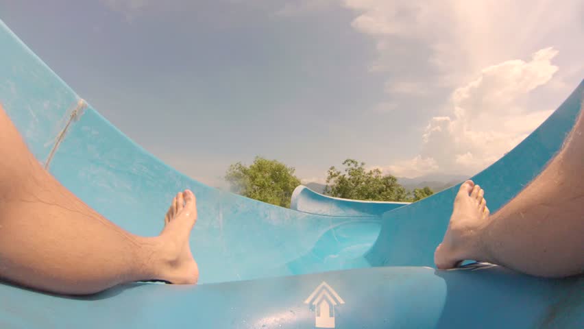 Rider's perspective of sliding down a water slide.