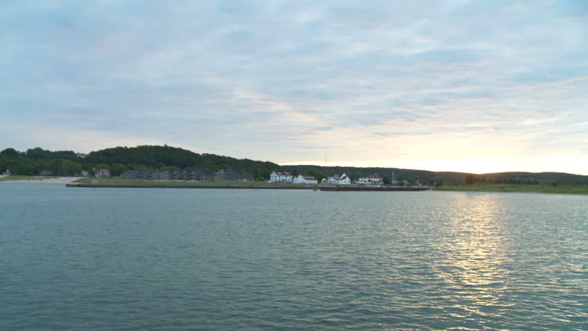 Dawn on the coast of Lake Michigan.  View of the harbor, looking towards the town of Frankfort, Michigan, with a pan around to the harbor entrance and lighthouse.