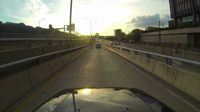 A high-angle perspective of driving onto the Fort Pitt Bridge leaving downtown