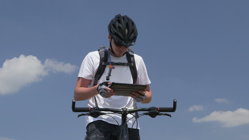 Mountain biker using digital tablet for GPS navigation