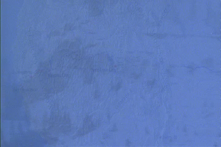 WS Sierra Nevada mountains, camera pans left over snowy range dotted with evergreen trees through dim light and haze in Truckee, California.