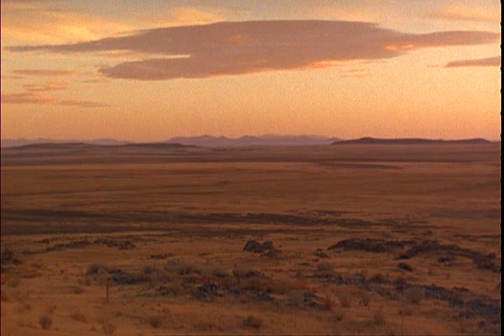 WS sunset over the flat prairie. Sierra Nevada mountains far off in the distance in Promontory, Utah.